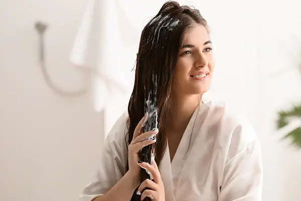 Girl using conditioner for better hair care